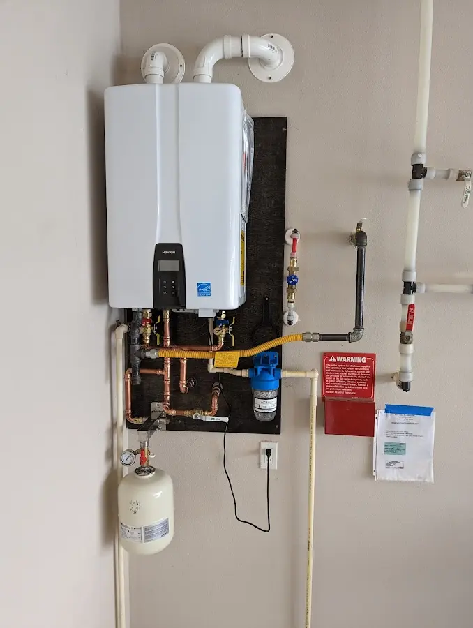 Professional plumber installing copper piping in a Astoria home